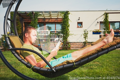 Image of Man resting in the garden of the house