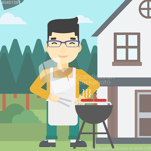 Image of Man cooking meat on barbecue grill.