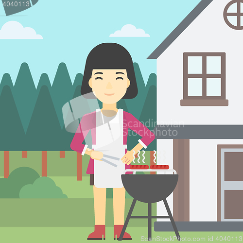 Image of Woman cooking meat on barbecue grill.