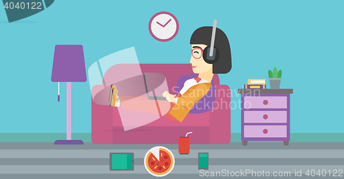 Image of Woman lying on sofa with many gadgets.