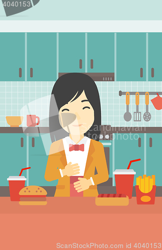 Image of Satisfied woman eating fast food.