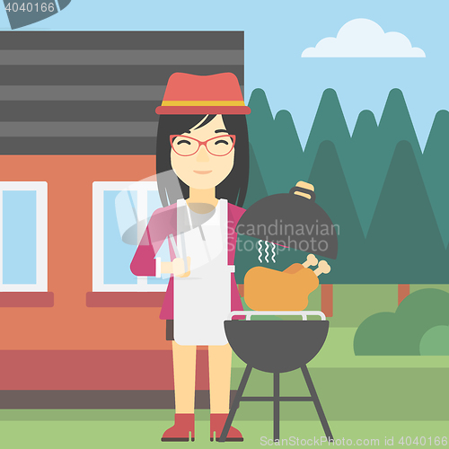 Image of Woman cooking chicken on barbecue grill.