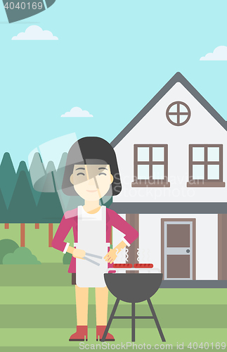 Image of Woman cooking meat on barbecue grill.