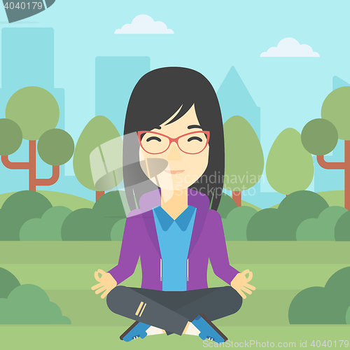 Image of Business woman meditating in lotus position.