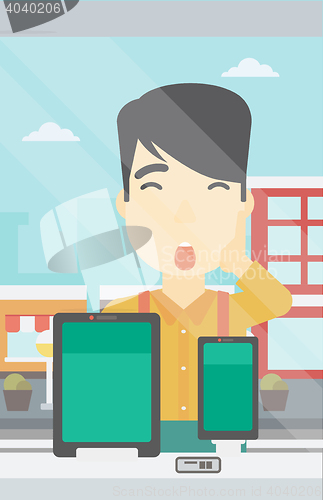 Image of Man looking at digital tablet and smartphone.
