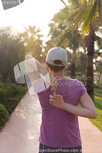 Image of woman  stretching before morning jogging