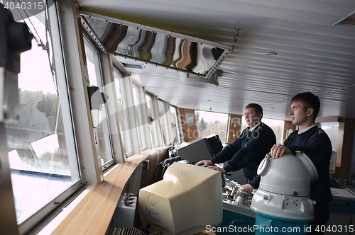 Image of Captain driving the ship on the river.