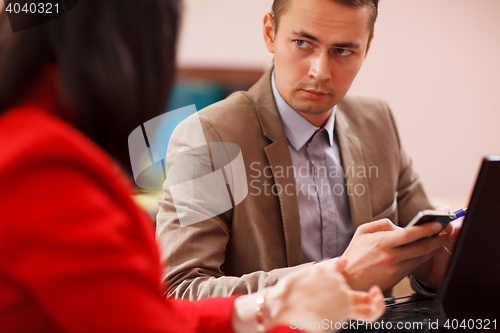 Image of Businessman listening to a colleague