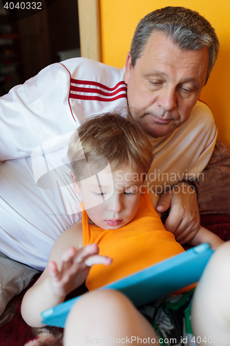 Image of Grandfather and grandson with touch pad