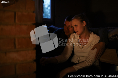 Image of Couple warming near stove