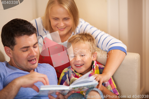 Image of Family reading book together at home