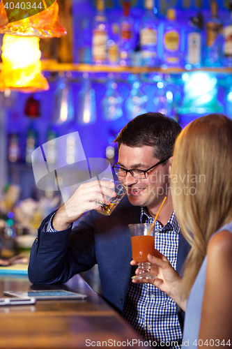 Image of Handsome man enjoying drinks with a woman