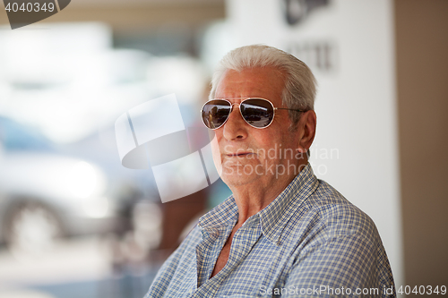 Image of Portrait of elderly man in sunglasses