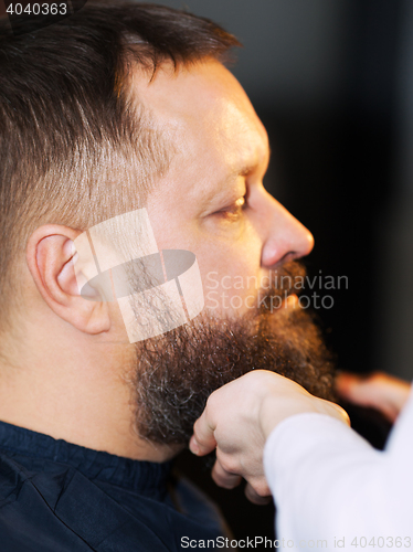 Image of Side view of adult man at barbershop