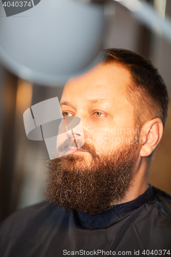 Image of Attractive bearded man in a barber shop