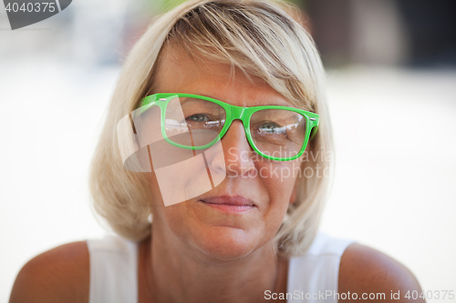 Image of Middle-aged woman wearing trendy eyeglasses