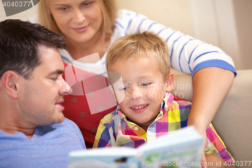 Image of Young family reading a book together