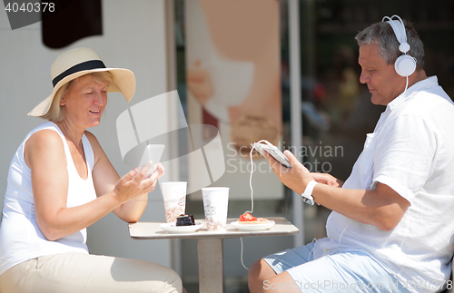 Image of Middle-aged couple relaxing on summer vacation