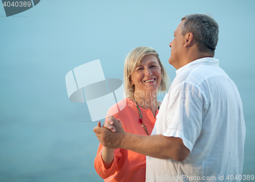 Image of Middle-aged couple dancing on a romantic song