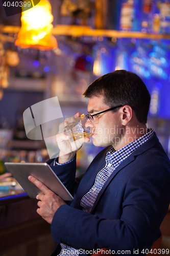 Image of Businessman enjoying a drink at a club