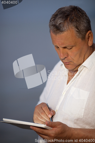 Image of Man Using Pen on Handheld Tablet Computer