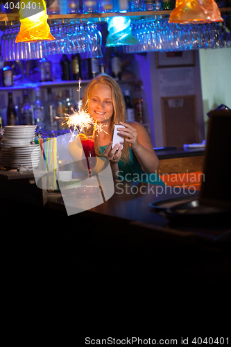 Image of Attractive woman celebrating in a night club