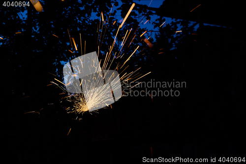 Image of Worker cutting metal with grinder. Sparks while grinding iron