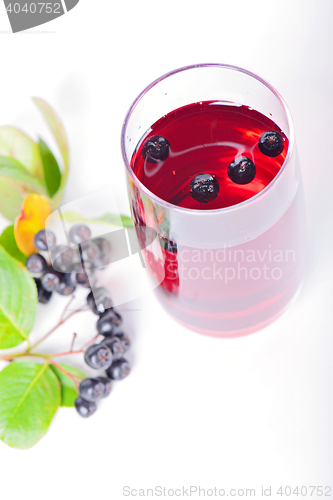 Image of Glass of aronia juice with berries, overhead view