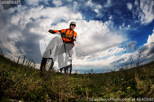 Image of Young man travel by bicycle on rural road