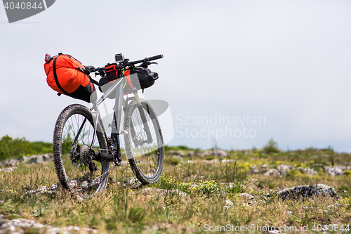 Image of Bicycle with orange bags for travel