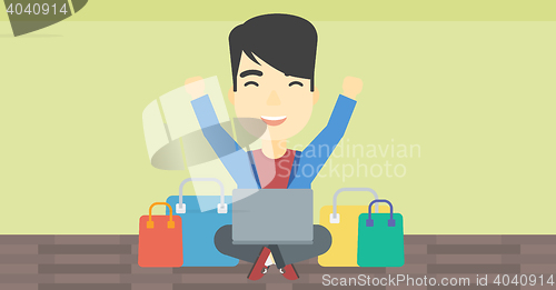 Image of Man shopping online using his laptop.