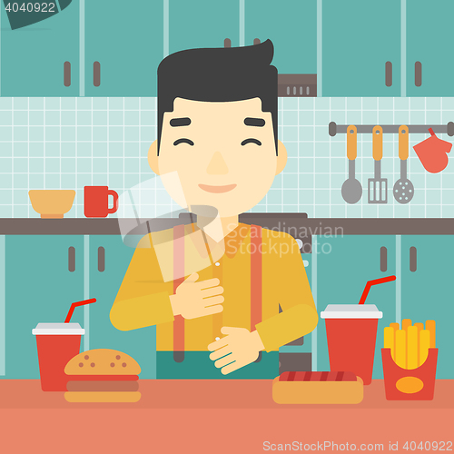 Image of Satisfied man eating fast food.