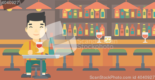 Image of Man drinking wine at restaurant.