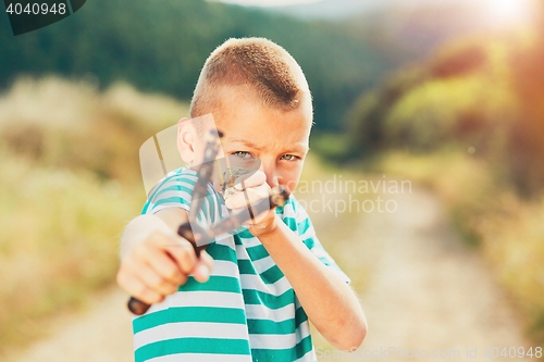 Image of Boy with slingshot