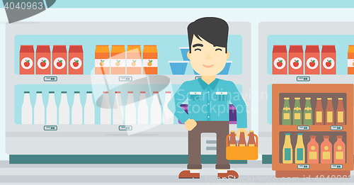 Image of Man with pack of beer at supermarket.