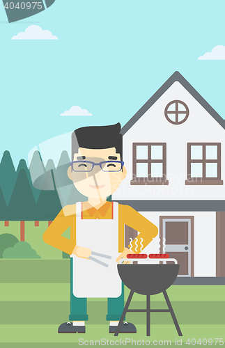 Image of Man cooking meat on barbecue grill.