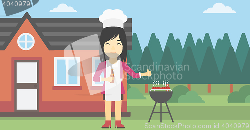 Image of Woman cooking meat on gas barbecue grill.