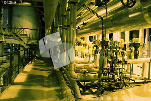 Image of Pipes, tubes, machinery and steam turbine at a power plant