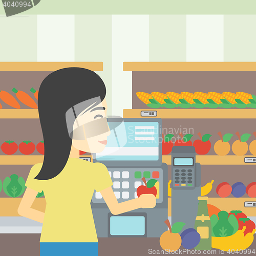 Image of Cashier standing at the checkout in supermarket.