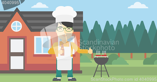 Image of Man cooking meat on gas barbecue grill.