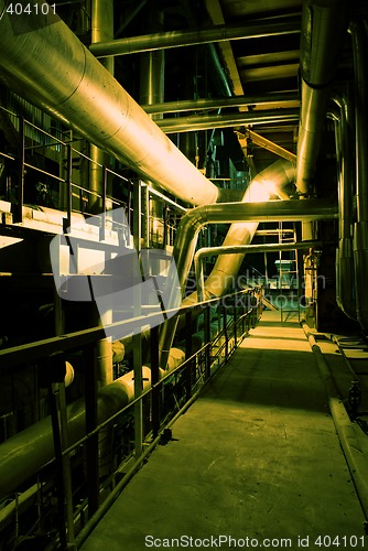 Image of Pipes, tubes, machinery and chimney at a power plant