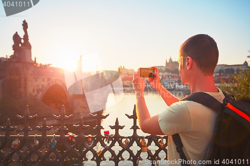 Image of Traveler taking photo by mobile phone