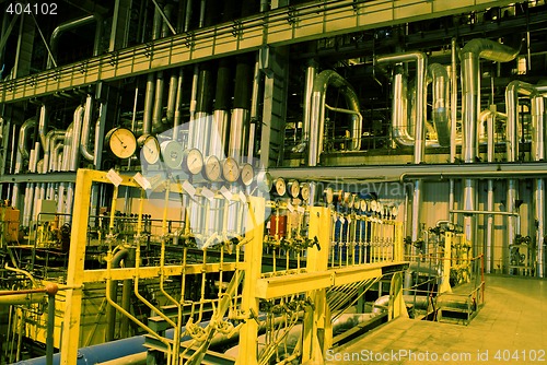 Image of Pipes, tubes, machinery and steam turbine at a power plant