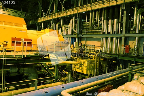 Image of Pipes, machinery, tubes and turbine at a power plant