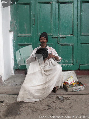 Image of Streets of Kolkata. street hairdresser