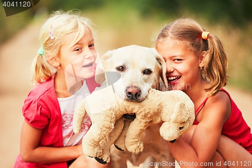 Image of Sisters with dog. 