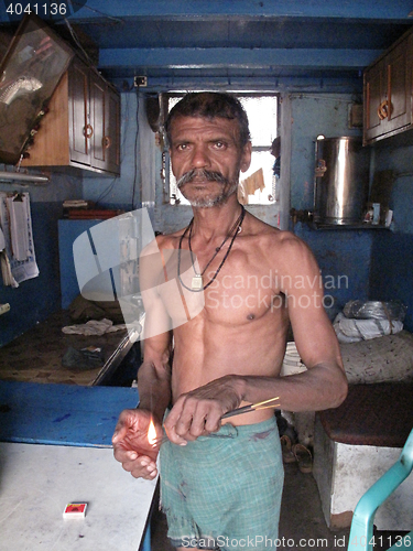 Image of Streets of Kolkata. Hindu prayer, Man burns joss sticks