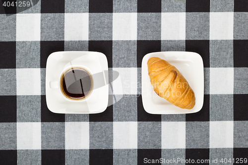 Image of Coffee cup with saucer and croissant