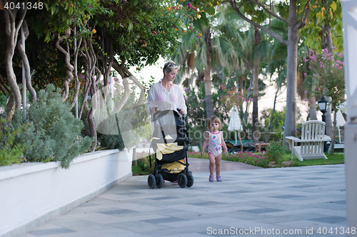 Image of girl and mother walking