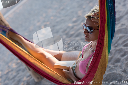 Image of relaxed woman laying in hammock